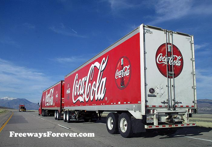 Bright red Coca-Cola truck with double trailer on Interstate 15 in Utah