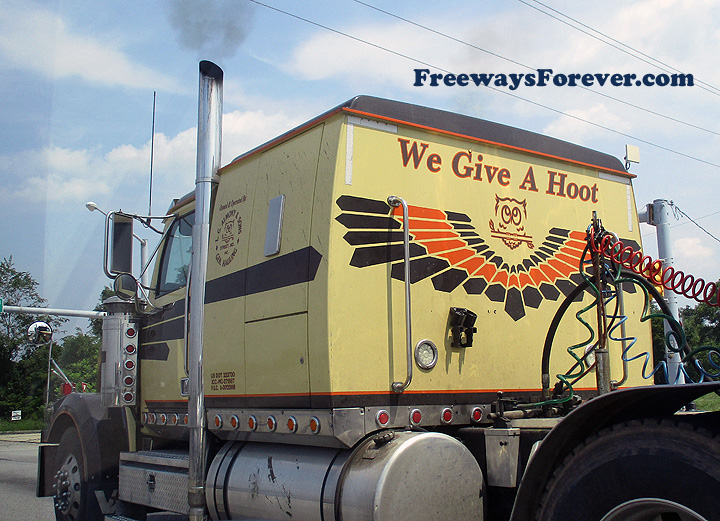 Close-up detail view of L.G. Almony and Sons truck with owl graphics